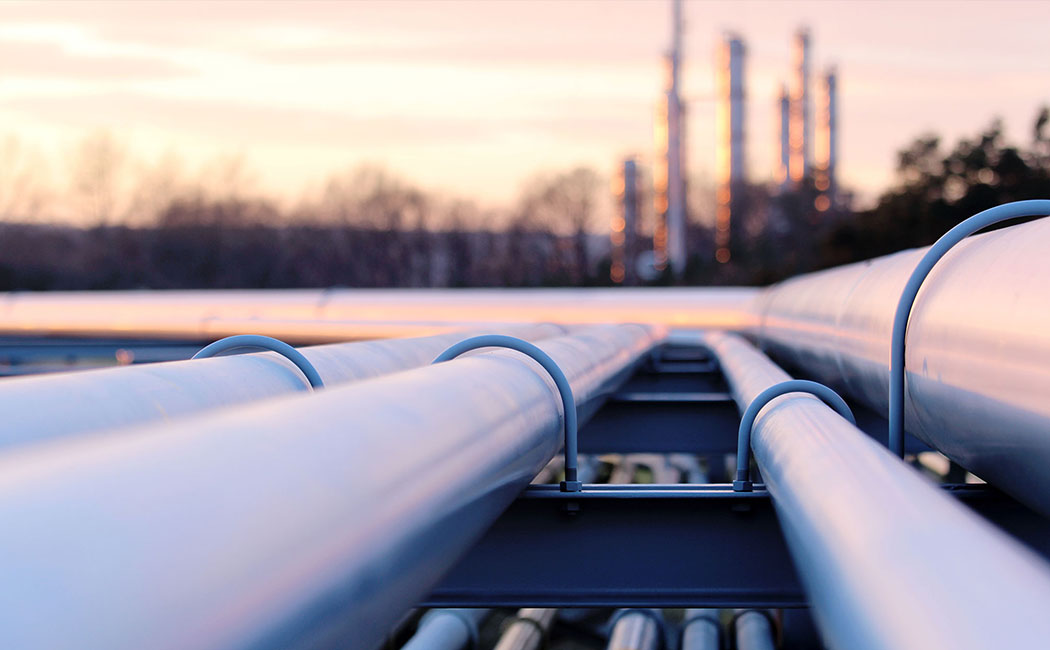 steel long pipes in crude oil factory during sunset