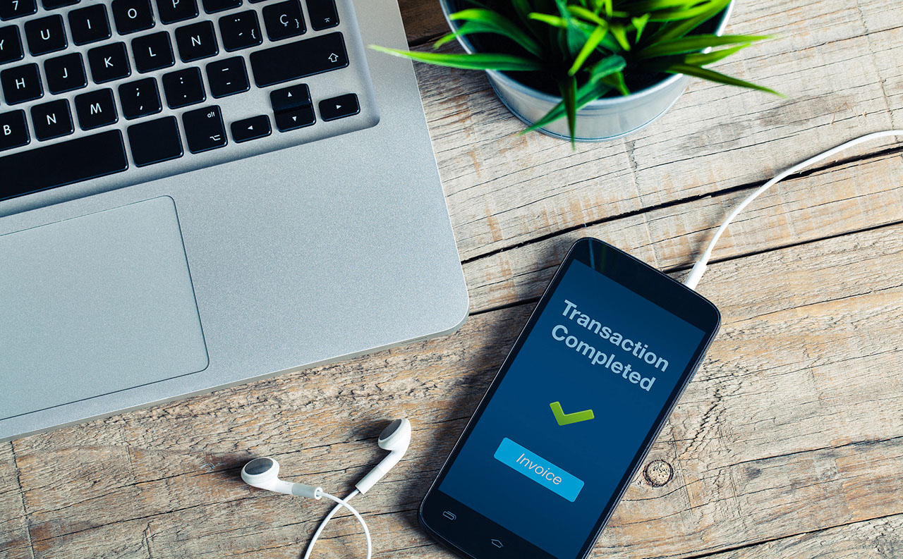 Transaction Completed message on smart phone screen. Detail of workplace., Transaction Completed message on smart phone screen. Detail of w
