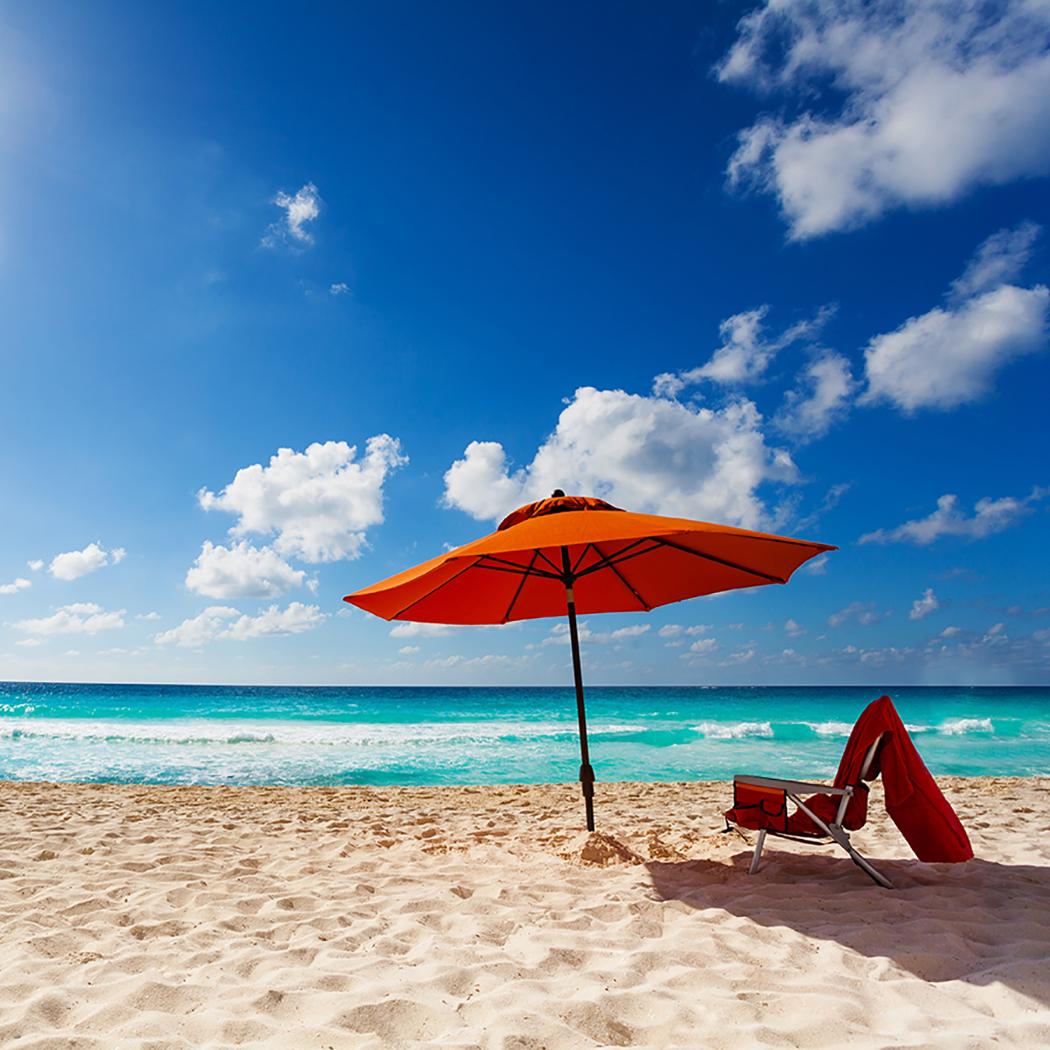 orange beach umbrella on beach